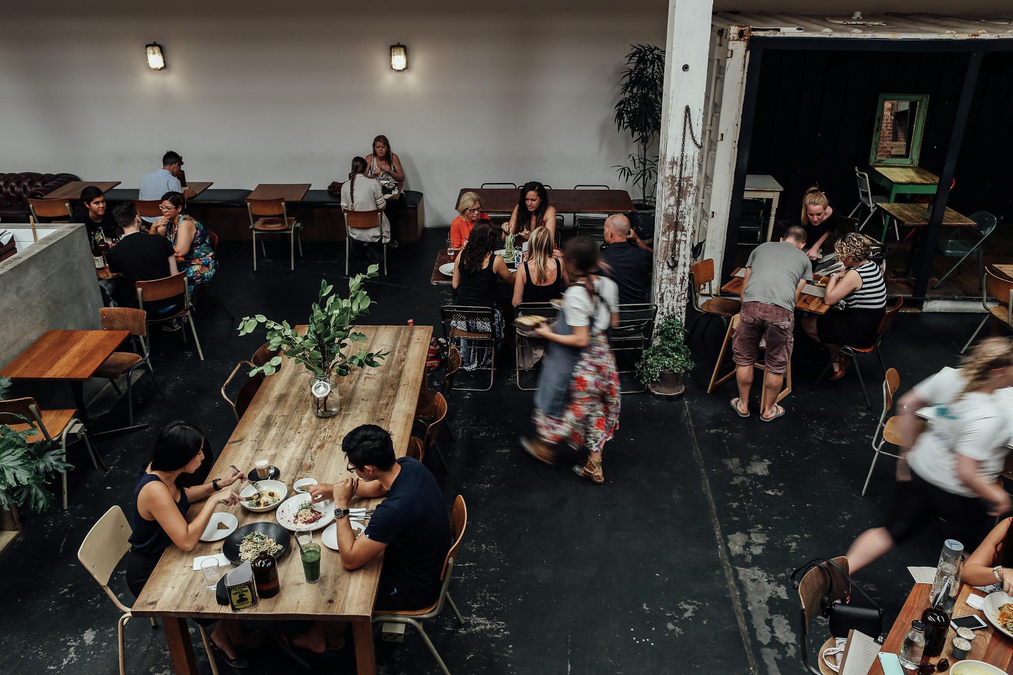 Indoor view of a busy restaurant with people enjoying meals at tables.